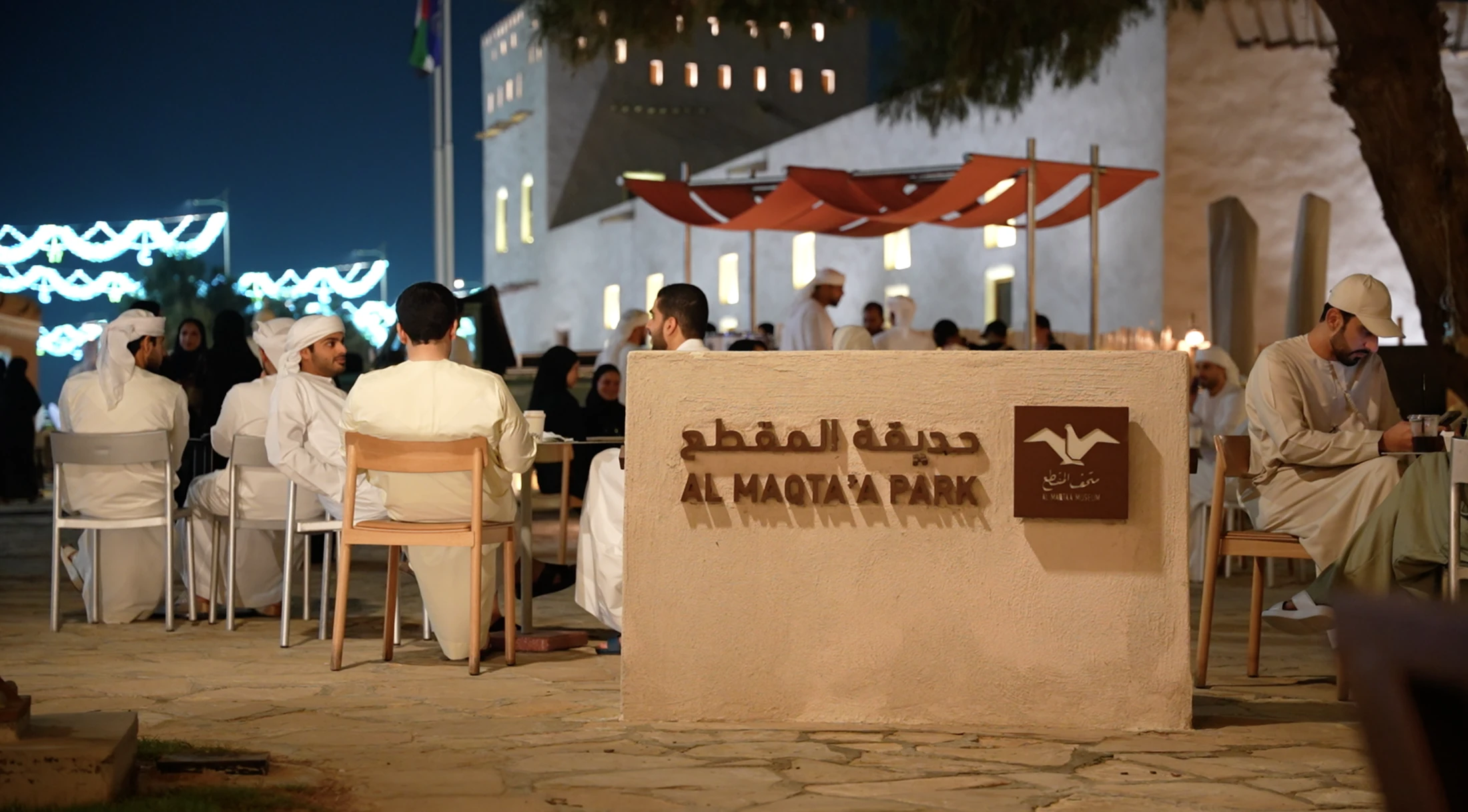 Gathering beside the Al Maqta’a Park sign and museum.